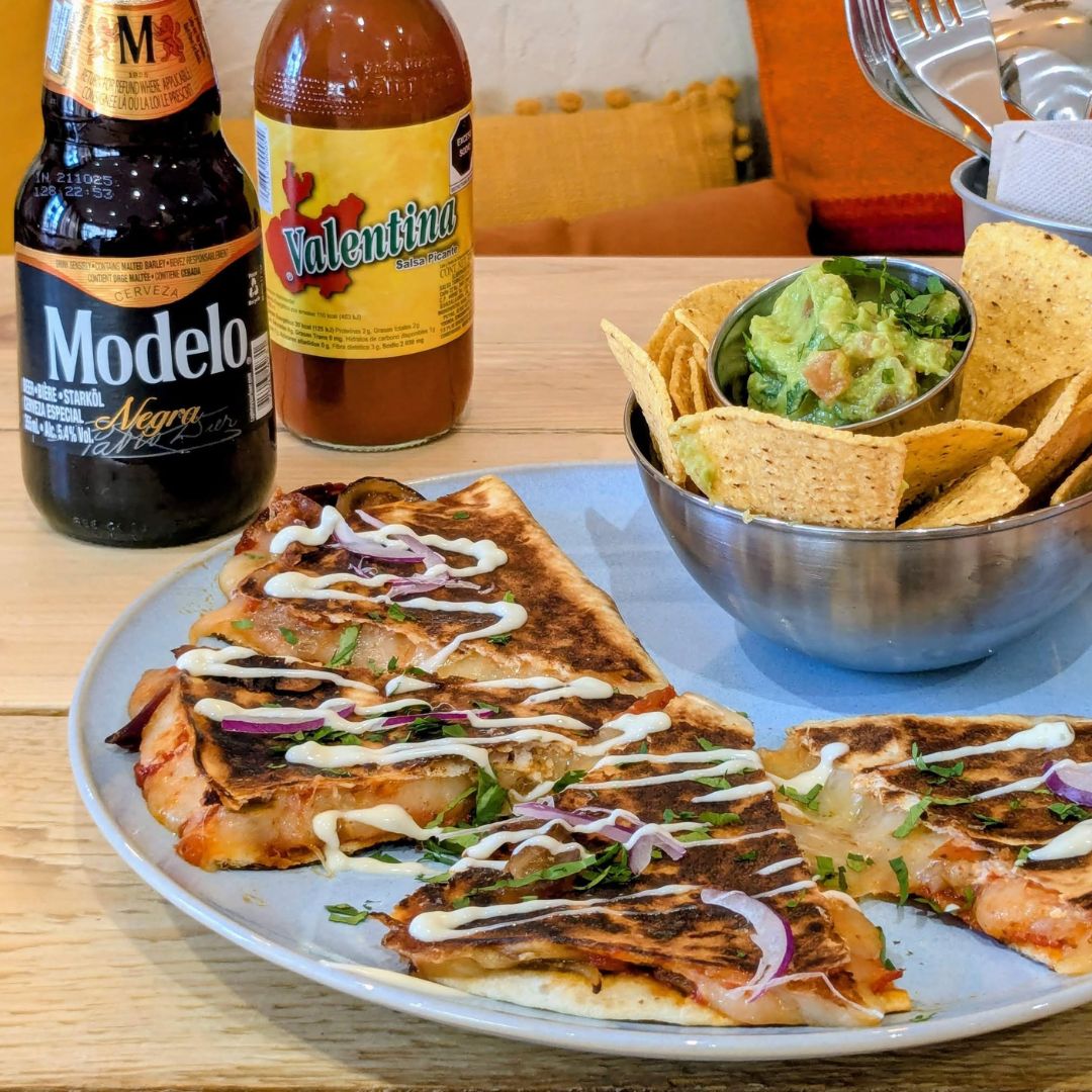 Quesadilla de carne servie avec guacamole et nachos